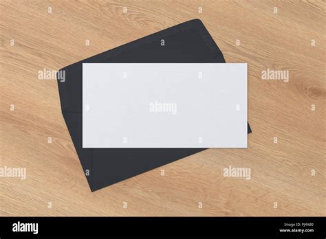 Blank letter on black blank envelope on wooden background. 3d render ...