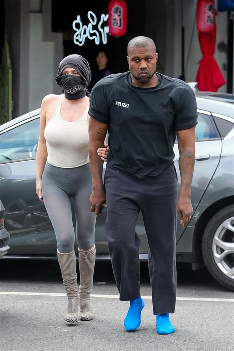 Kanye West sports bizarre shoulder pads as Kim Kardashian accuses him ...